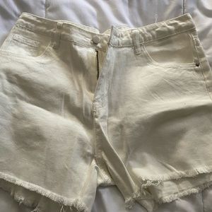 White ripped shorts